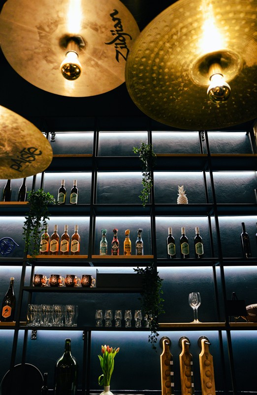 Zildjian cymbals used as lamps above the backlit shelves at achtundzwanzig, Vienna 1080