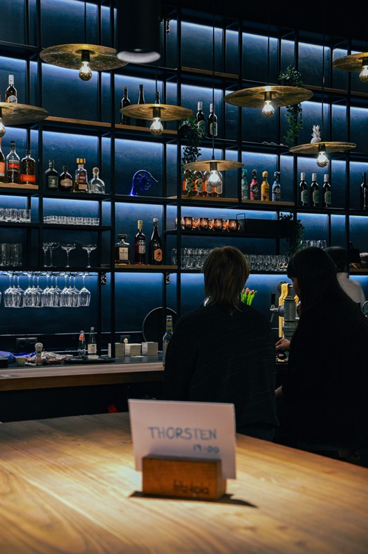 A reserved table in front of the busy bar