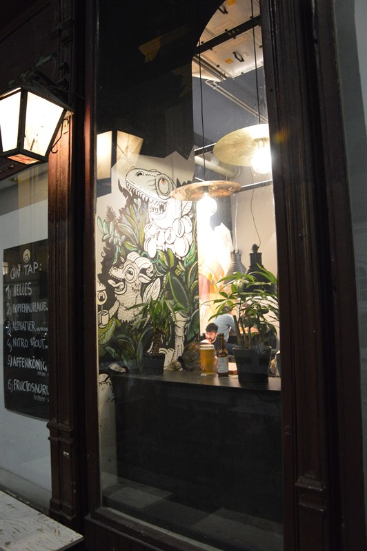 The bar window at night with lantern, mural and plants