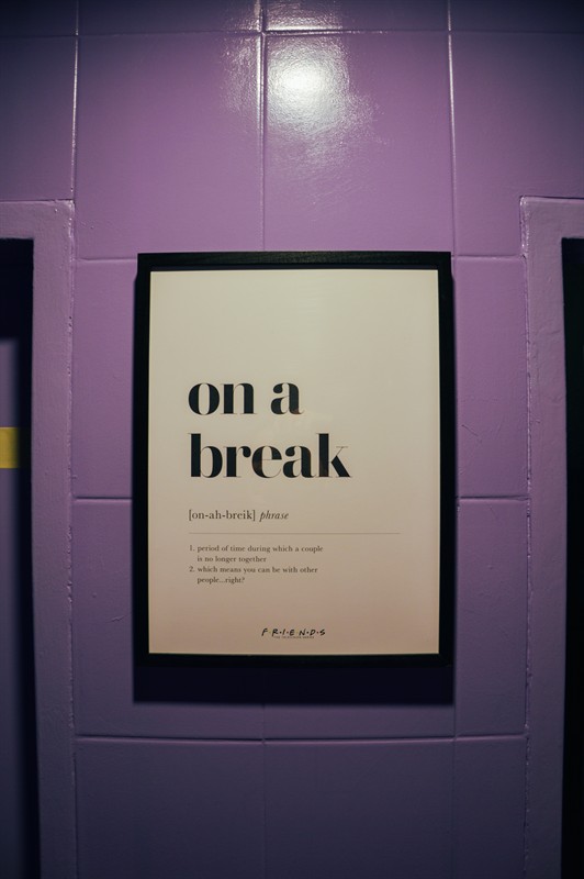 The ‘on a break’ poster on purple tiles
