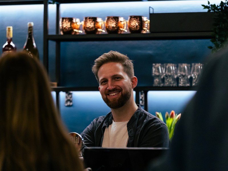Our bartender laughing behind the counter