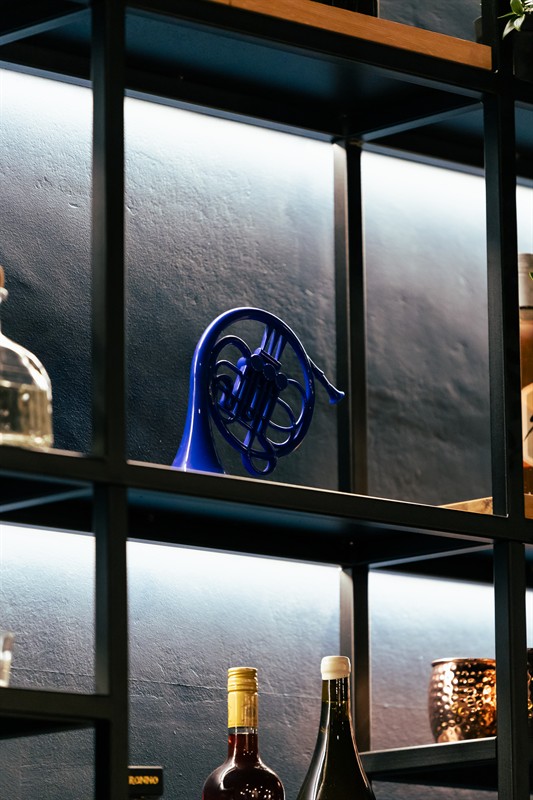 The blue horn on the backlit shelf