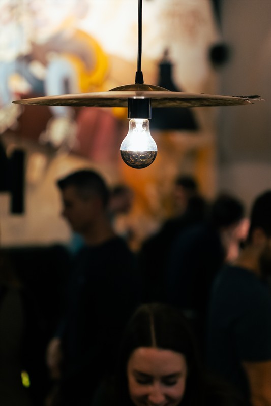 Brass lamp in front of the mural