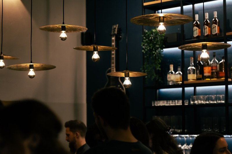 The room under brass pendant lamps